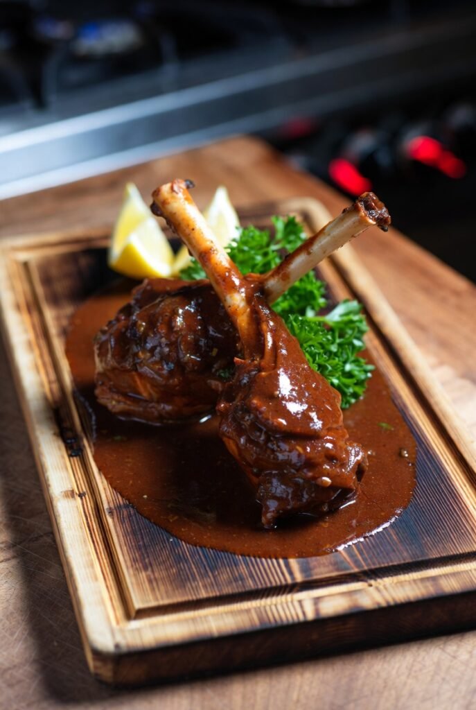 Saucy Glazed Lamb Shanks on Wood Board